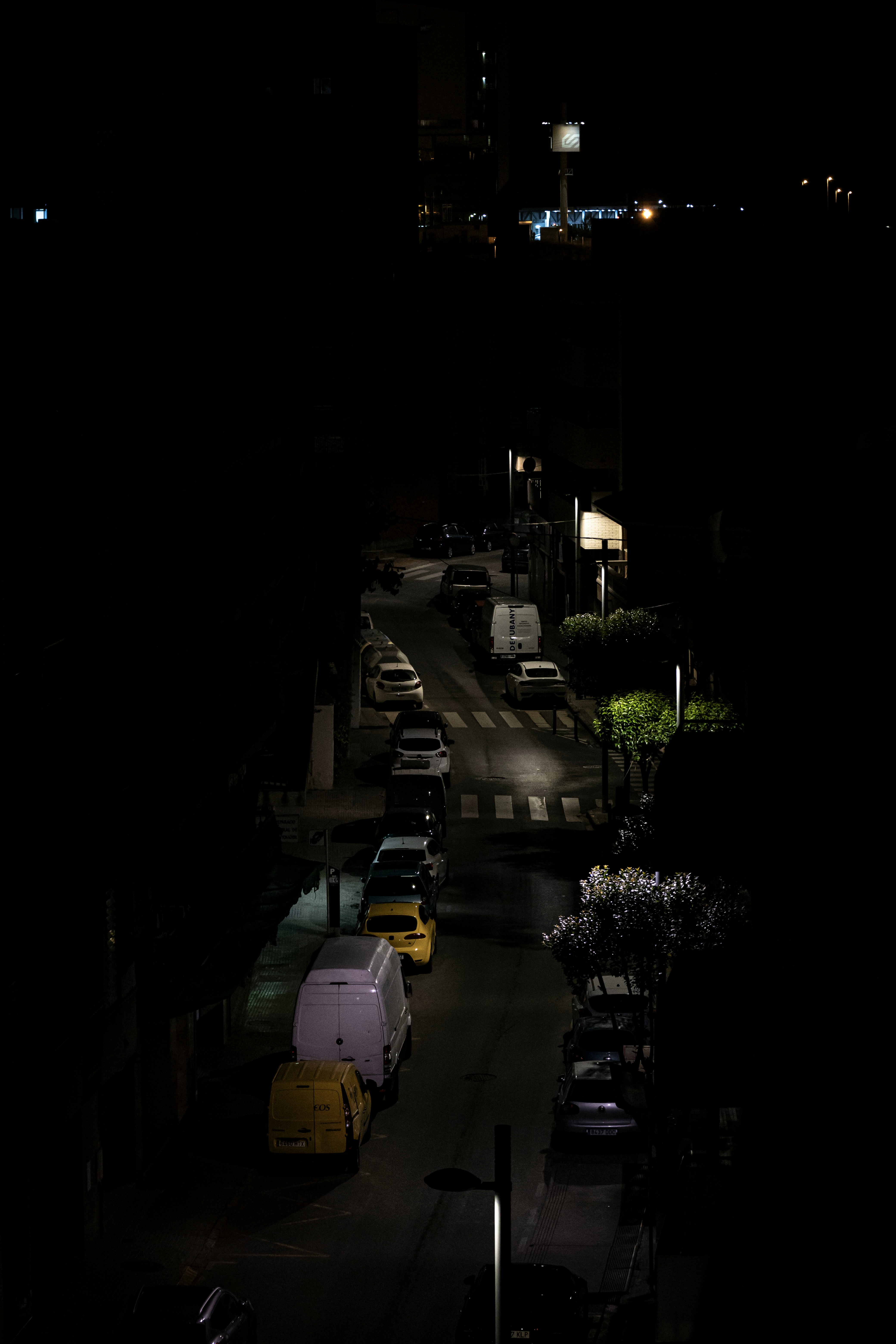 cars parked on the side of the road during night time